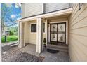 Home entrance with decorative security door, small porch, and tan siding at 1011 Pierce St # 11, Lakewood, CO 80214