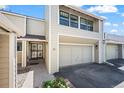 Two-story townhouse with garage and entry door featuring an ornate security gate at 1011 Pierce St # 11, Lakewood, CO 80214