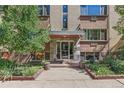 Apartment building entrance featuring glass doors and manicured landscaping at 10 N Ogden St # 5, Denver, CO 80218