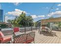 Relaxing rooftop deck with seating area and city views at 10 N Ogden St # 5, Denver, CO 80218