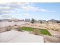 Spacious backyard with a white fence, rock landscape, and a small area of grass at 5325 Ventura St, Denver, CO 80249