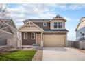 Charming two-story home featuring a two-car garage and manicured lawn at 5325 Ventura St, Denver, CO 80249
