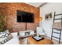 Inviting living room showcasing exposed brick, modern furnishings, and stylish decor for a cozy atmosphere at 2524 Champa St # 4, Denver, CO 80205