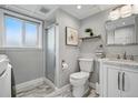 Bright bathroom showcases a glass shower, marble vanity, and updated fixtures at 11950 E Exposition Ave, Aurora, CO 80012