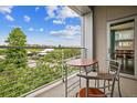 Cozy balcony features a small table with chairs and peaceful views of the green surroundings at 2958 Syracuse St # 317, Denver, CO 80238