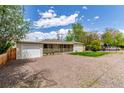 Cozy single-story home boasting a covered porch and a spacious gravel driveway surrounded by mature trees at 3501 W 53Rd Ave, Denver, CO 80221
