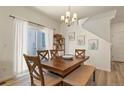 Bright dining room with wooden table, neutral chairs, and large sliding glass doors at 23920 E 34Th Ave, Aurora, CO 80019