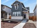 Charming two-story home featuring vertical siding, a stone accent wall, and a well-manicured front yard at 23920 E 34Th Ave, Aurora, CO 80019