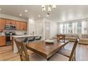 Open living space features a dining table, kitchen with island, and comfortable seating area at 23920 E 34Th Ave, Aurora, CO 80019
