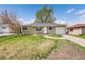 Charming single-story home featuring a well-maintained front yard, inviting entrance, and attached garage at 1243 S Tejon St, Denver, CO 80223