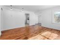 Bright and empty living room with hardwood floors, white walls, and recessed lights at 1570 Xanthia St, Denver, CO 80220