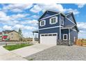 Charming two-story home featuring blue siding, white trim, and a well-manicured front lawn at 17959 Dandy Brush Ln, Parker, CO 80134