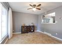 Cozy dining room with tile floors, neutral gray walls, a ceiling fan and decorative furniture at 321 S 26Th Ave, Brighton, CO 80601