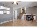 Open-concept living room featuring tile floors, staircase, and easy access to kitchen at 321 S 26Th Ave, Brighton, CO 80601