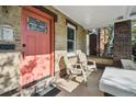 Relaxing front porch seating area with a vibrant front door offering a warm welcome to guests at 1633 Gaylord St, Denver, CO 80206