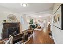 Cozy living room with a traditional fireplace, hardwood floors, and ample natural light at 1633 Gaylord St, Denver, CO 80206