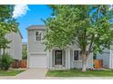 Charming two-story home with a well-manicured lawn and attached garage at 11845 W Tulane Dr, Morrison, CO 80465
