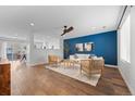 Bright living room featuring a striking blue accent wall and modern decor at 11845 W Tulane Dr, Morrison, CO 80465