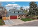 Charming two-story home with a well-manicured lawn and eye-catching brick and siding exterior at 6930 S Yukon Way, Littleton, CO 80128