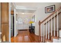Hardwood floors and staircase leading upstairs; view of front door at 4806 Jericho Ct, Denver, CO 80249