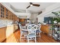 Spacious kitchen with an island and breakfast bar, hardwood floors and lots of cabinets at 4806 Jericho Ct, Denver, CO 80249