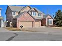 Beautiful two-story home featuring a three-car garage, brick accents, and a well-kept front yard at 2713 Slate Ct, Superior, CO 80027