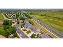 Aerial view showcases homes in a tranquil neighborhood, backing to open space and greenbelt at 6950 Blue Mesa Ln, Littleton, CO 80125