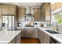 Well-equipped kitchen featuring quartz countertops, stainless steel appliances, and an island at 6950 Blue Mesa Ln, Littleton, CO 80125