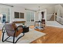 Inviting living room with gleaming wood floors and an open layout to the dining area at 2880 Emporia Ct, Denver, CO 80238