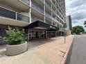 Condominium building entrance featuring a covered entrance with glass doors, planters, and a glimpse of balconies at 888 N Logan St # 2C, Denver, CO 80203