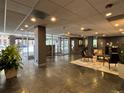 The building's lobby features tile flooring, seating, and a view of the entry doors at 888 N Logan St # 2C, Denver, CO 80203