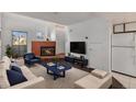 Bright living room features a fireplace, stylish furnishings, and modern entertainment center at 17053 E Tennessee Dr # 212, Aurora, CO 80017