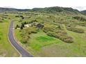 Aerial view of an estate situated on lush land, with a long driveway leading to the beautiful house at 580 Summer Mist Cir, Castle Rock, CO 80104