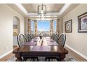 Formal dining room featuring a large wooden table and picturesque bay window view at 286 Claymoor Ct, Castle Pines, CO 80108