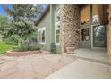 Inviting entryway with stone accents, large windows and quaint chair at 12671 W Dakota Dr, Lakewood, CO 80228