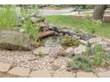 Charming rock garden with small decorative fish pond with stacked rocks at 12671 W Dakota Dr, Lakewood, CO 80228