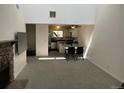 Open-concept living and dining area featuring a fireplace and vaulted ceilings at 8657 Clay St # 383, Westminster, CO 80031