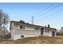 Charming single-story home with a brick facade and well-maintained front yard at 8097 E Lehigh Dr, Denver, CO 80237