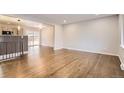 Spacious living room with beautiful hardwood floors and an open concept design at 8097 E Lehigh Dr, Denver, CO 80237