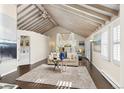 Bright living room with vaulted ceiling, exposed beams, neutral decor, and comfortable seating arrangement at 700 Holly St, Denver, CO 80220