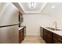 Modern kitchen featuring stainless steel appliances, and stylish cabinets at 4896 S Dudley St # 8, Littleton, CO 80123