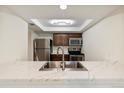 Well-lit kitchen featuring stainless steel appliances, modern cabinetry, and attractive countertops at 4896 S Dudley St # 8, Littleton, CO 80123