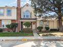 Townhome exterior with walkway and landscaping at 9618 W Chatfield Ave # E, Littleton, CO 80128