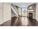 Living room with hardwood floors, fireplace and staircase at 9618 W Chatfield Ave # E, Littleton, CO 80128