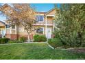 Charming townhome with well-maintained landscaping, brick accents, and a welcoming entrance at 6809 S Webster St # F, Littleton, CO 80128