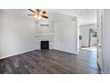 Modern living room with a stylish fireplace, hardwood floors, and neutral color palette at 6809 S Webster St # F, Littleton, CO 80128