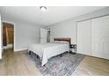 Bedroom with light gray walls, wood flooring, and closet at 9175 Cole Dr, Arvada, CO 80004