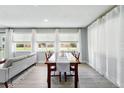 Sunlit dining room with wood table, chairs, neutral walls, and large windows at 9175 Cole Dr, Arvada, CO 80004