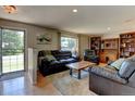 Comfortable living room featuring plush leather furniture and hardwood floors at 6775 Coors Ct, Arvada, CO 80004