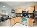 Close up of the kitchen featuring stainless steel appliances, modern cabinets, and granite countertops at 2895 W Riverwalk Cir # 104, Littleton, CO 80123